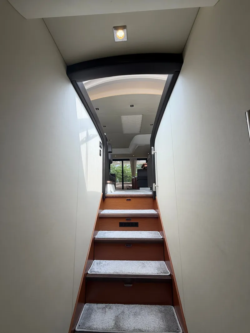 Slide: The Image of A staircase leads to an elegant interior with modern furnishings and large windows. - 25