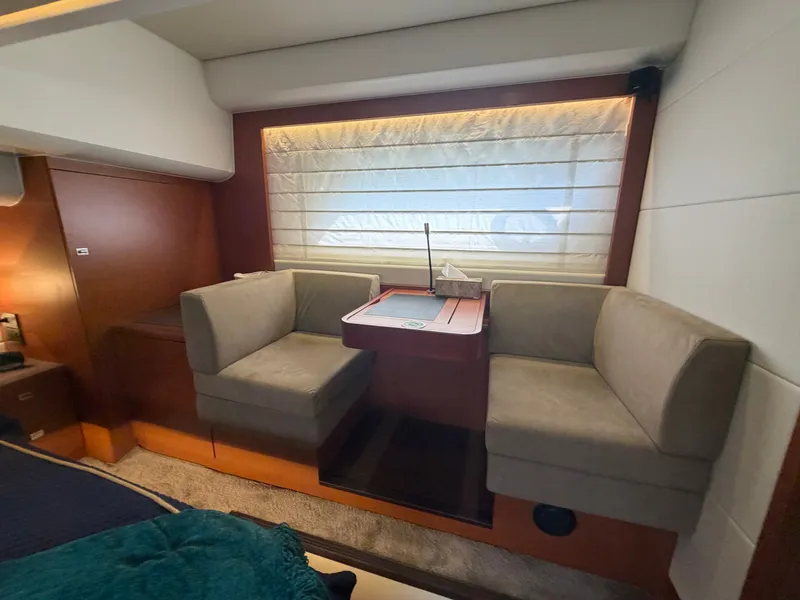 Slide: The Image of Interior of a 2015 Prestige 550 with two beige seats and a table. - 38