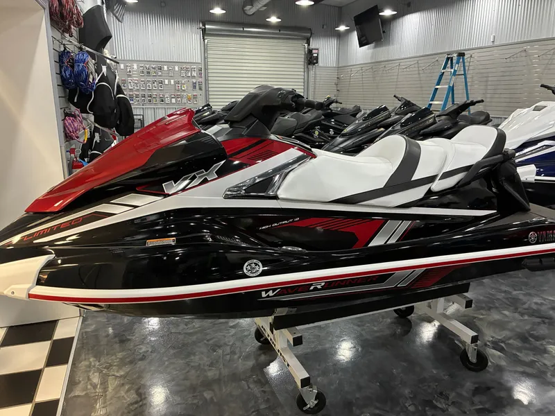 The Image of A 2018 Yamaha VX Limited jet ski in a showroom, featuring a red and black design. - 1