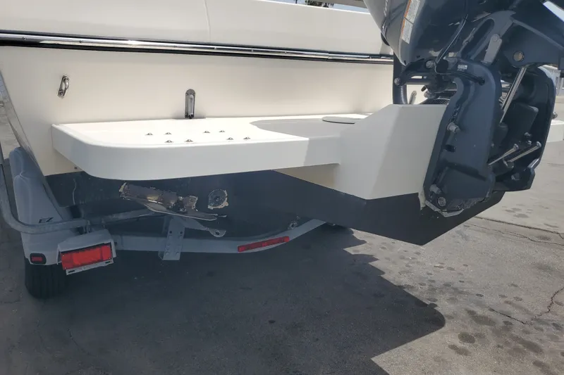 Slide: The Image of 2022 Defiance Commander 220 EX boat stern with outboard motor on trailer. - 23
