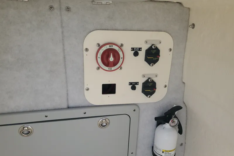 Slide: The Image of Control panel and fire extinguisher inside 2022 Defiance Commander 220 EX boat. - 8