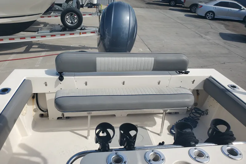 Slide: The Image of 2022 Defiance Commander 220 EX boat interior with seating and fishing rod holders. - 16