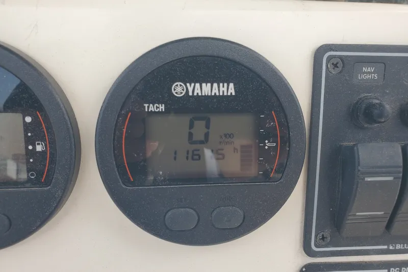 Slide: The Image of Yamaha tachometer on 2022 Defiance Commander 220 EX boat dashboard, showing 1165 hours. - 27