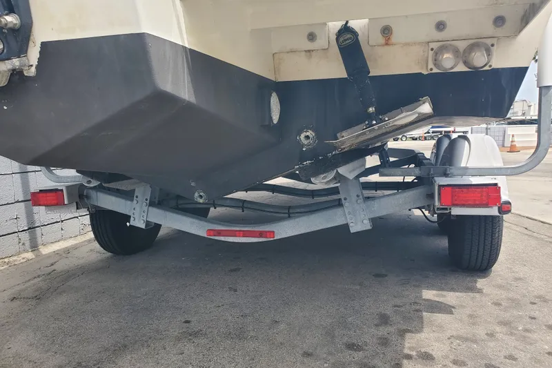Slide: The Image of 2022 Defiance Commander 220 EX boat on trailer, rear view, parked on concrete. - 22