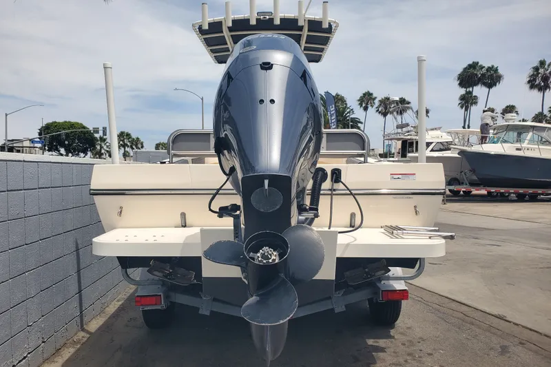 Slide: The Image of 2022 Defiance Commander 220 EX boat with powerful outboard motor, parked at marina. - 4