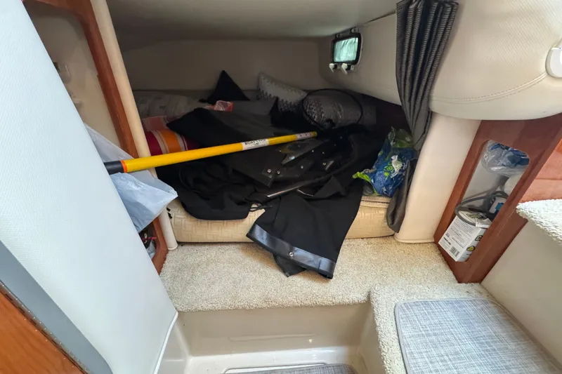 Slide: The Image of Interior cabin of 2008 Four Winns V248 boat with storage items and cushions. - 16