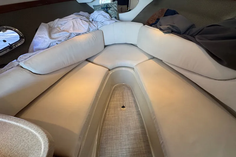Slide: The Image of Interior cabin of 2008 Four Winns V248 boat with beige seating and bedding. - 15