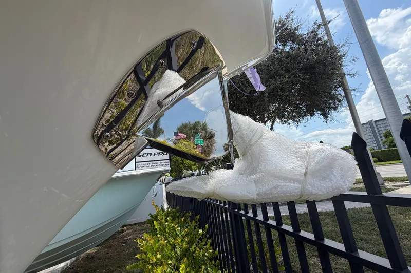 Slide: The Image of 2027 Sea Pro 262 DLX boat detail with protective wrap, outdoor display. - 41