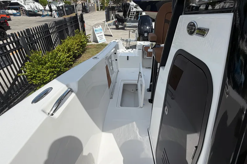 Slide: The Image of 2027 Sea Pro 262 DLX boat interior with open storage compartment and sleek design. - 46