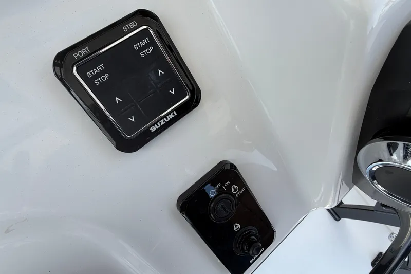 Slide: The Image of Close-up of 2027 Sea Pro 262 DLX boat controls featuring Suzuki start-stop panel. - 31