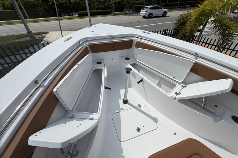 Slide: The Image of 2027 Sea Pro 262 DLX boat interior with open storage compartments and seating. - 16