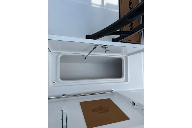 Slide: The Image of 2027 Sea Pro 262 DLX boat storage compartment with open hatch and interior view. - 34