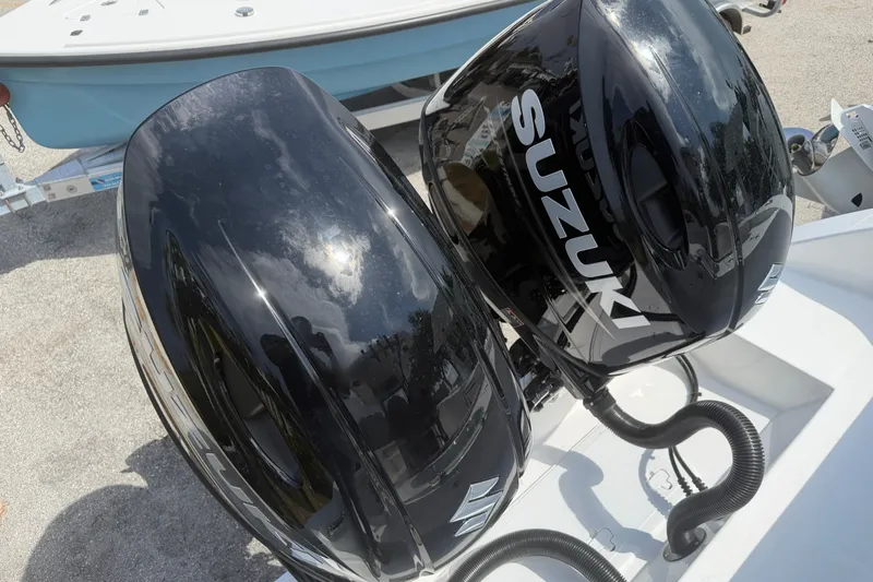 Slide: The Image of Twin Suzuki outboard motors on a 2027 Sea Pro 262 DLX boat. - 24