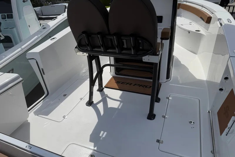Slide: The Image of 2027 Sea Pro 262 DLX boat interior with seating and storage compartments. - 19