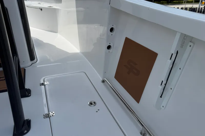 Slide: The Image of 2027 Sea Pro 262 DLX boat interior, featuring sleek white surfaces and stainless steel fittings. - 26