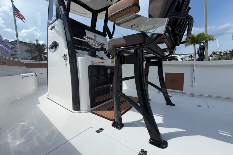Slide: The Image of 2027 Sea Pro 262 DLX boat interior with helm and seating, showcasing modern design. - 17