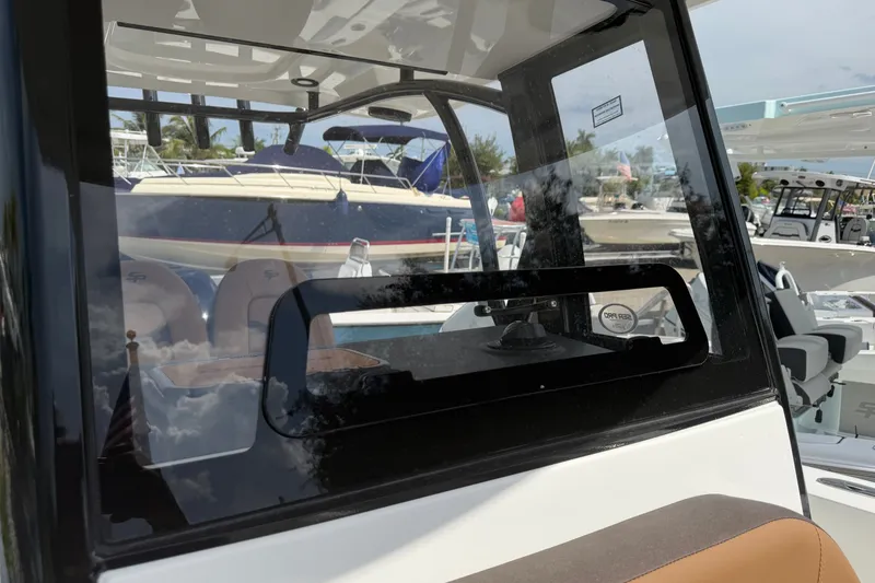 Slide: The Image of 2027 Sea Pro 262 DLX boat interior with clear glass window and seating. - 22