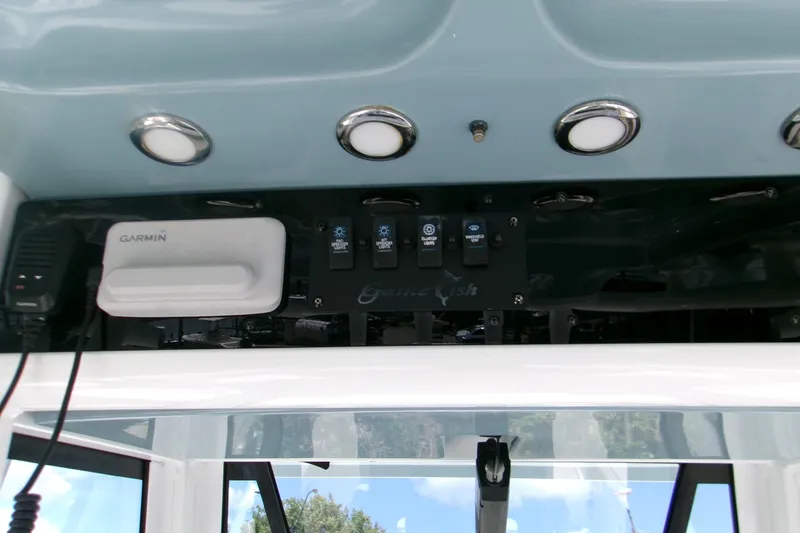 Slide: The Image of 2020 Sea Hunt Gamefish 25 dashboard with Garmin device and control switches. - 22