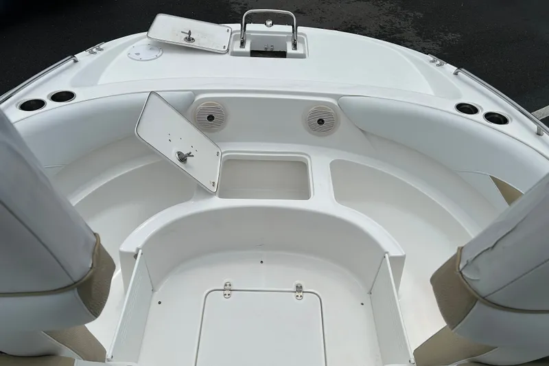Slide: The Image of 2013 SouthWind 212 SD boat interior with open storage compartments and cup holders. - 14