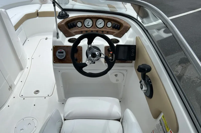 Slide: The Image of 2013 SouthWind 212 SD boat cockpit with steering wheel, gauges, and controls. - 12