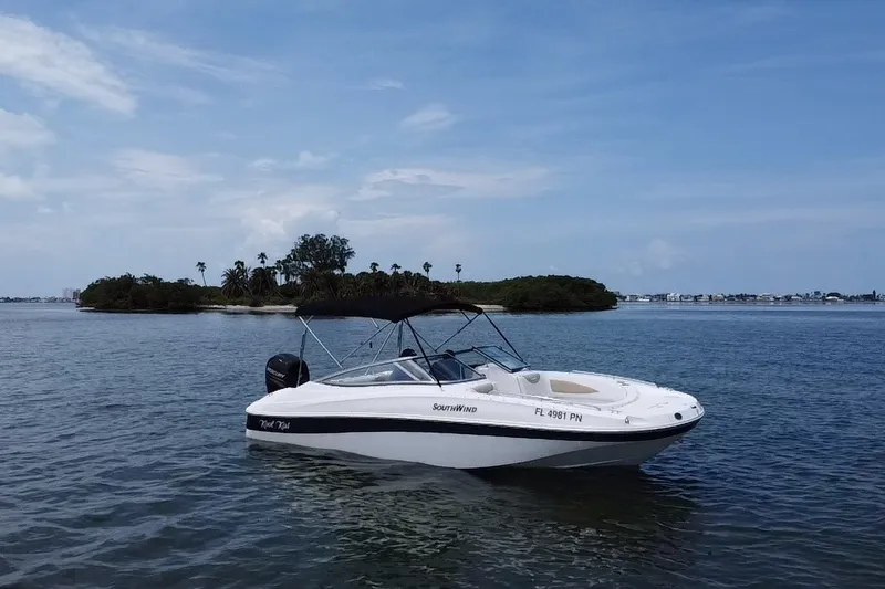 The Image of 2013 SouthWind 212 SD boat on calm water near a lush island under a clear blue sky. - 19