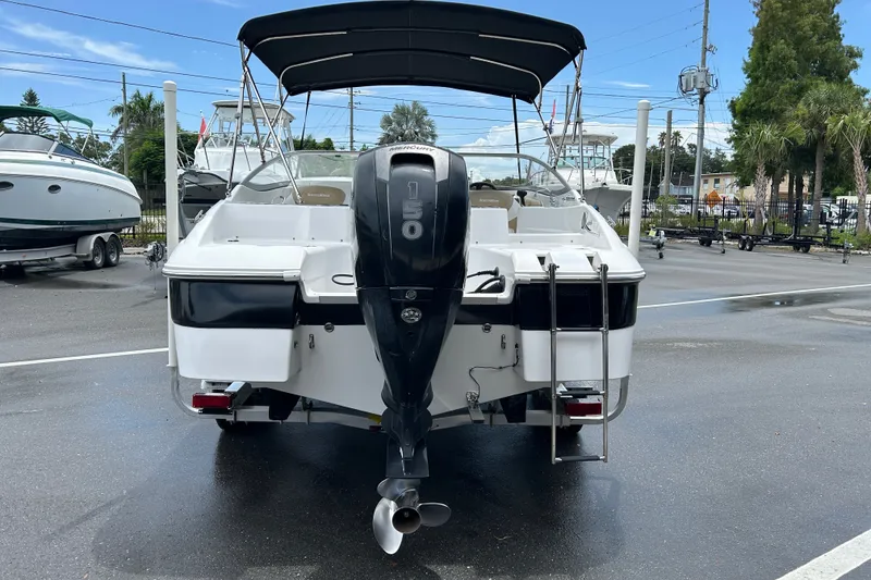Slide: The Image of 2013 SouthWind 212 SD boat with Mercury 150 engine, parked outdoors. - 3