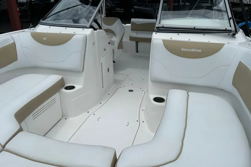 Slide: The Image of 2013 SouthWind 212 SD boat interior with white and beige seating, showcasing spacious design. - 9