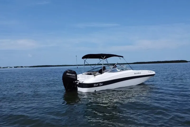 Slide: The Image of 2013 SouthWind 212 SD boat with Mercury engine on calm water under clear blue sky. - 20