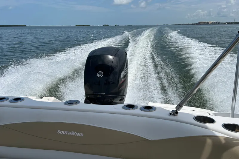 Slide: The Image of 2013 SouthWind 212 SD boat cruising on open water, leaving a wake behind. - 21