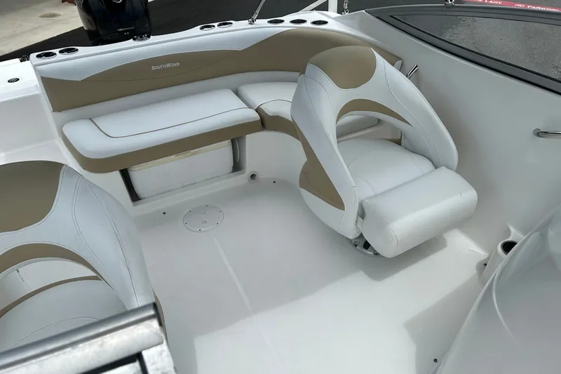 Slide: The Image of Interior of a 2013 SouthWind 212 SD boat with white and beige seating. - 11