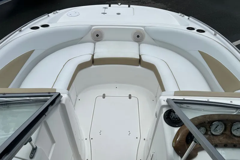 Slide: The Image of 2013 SouthWind 212 SD boat interior with white and beige seating, dashboard, and cup holders. - 8
