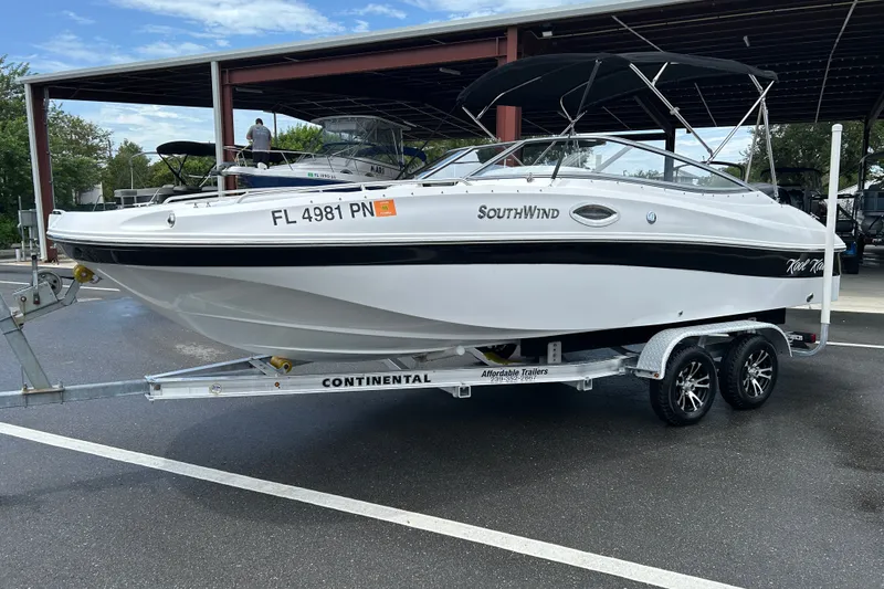 Slide: The Image of 2013 SouthWind 212 SD boat on trailer, parked outdoors under a canopy. - 5