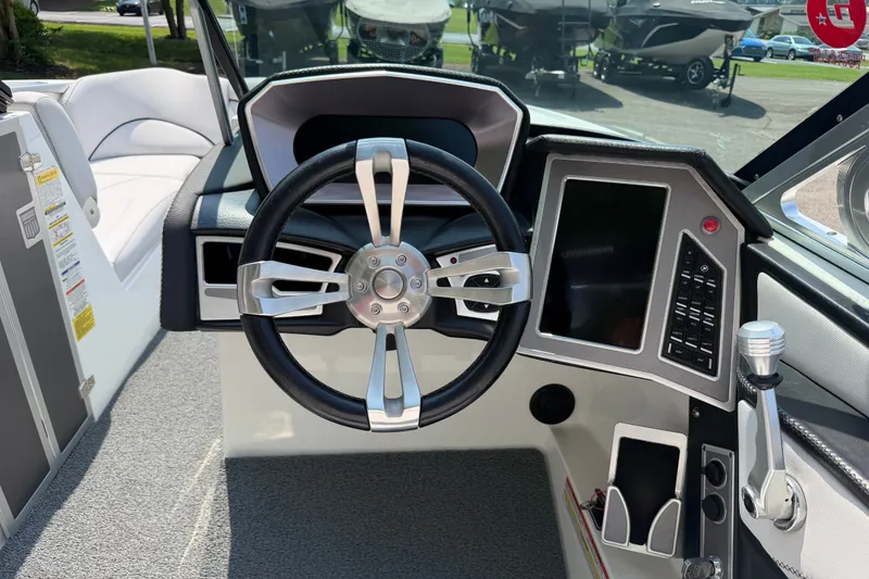 Slide: The Image of 2018 MasterCraft X46 boat dashboard with steering wheel and touchscreen controls. - 13
