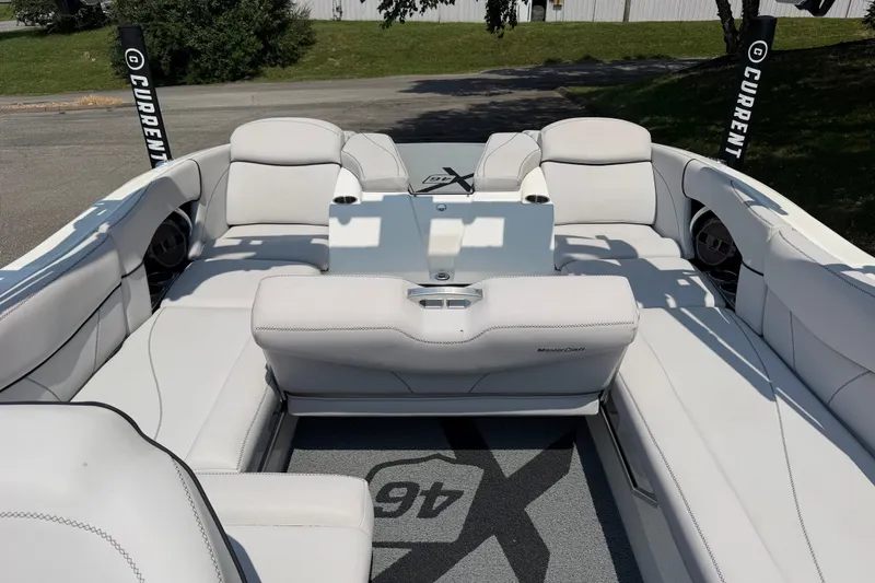 Slide: The Image of 2018 MasterCraft X46 boat interior with white seating and sleek design. - 6
