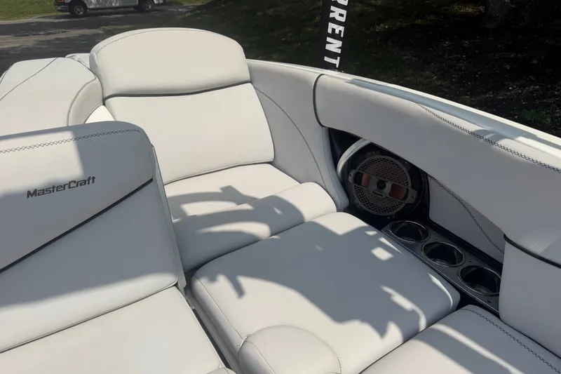 Slide: The Image of 2018 MasterCraft X46 boat interior with white leather seats and built-in speaker. - 9