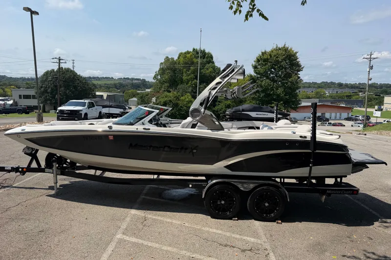 Slide: The Image of 2018 MasterCraft X46 boat on trailer in parking lot, side view. - 3