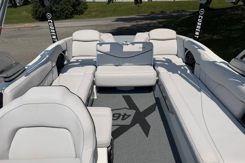 Slide: The Image of 2018 MasterCraft X46 boat interior with white seating and branded carpet. - 5