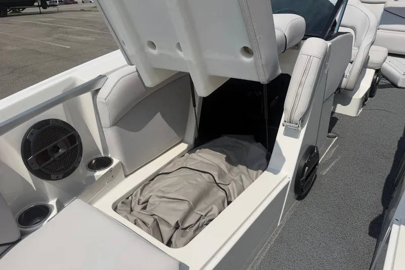 Slide: The Image of 2018 MasterCraft X46 boat interior storage compartment with speaker and cup holders. - 11