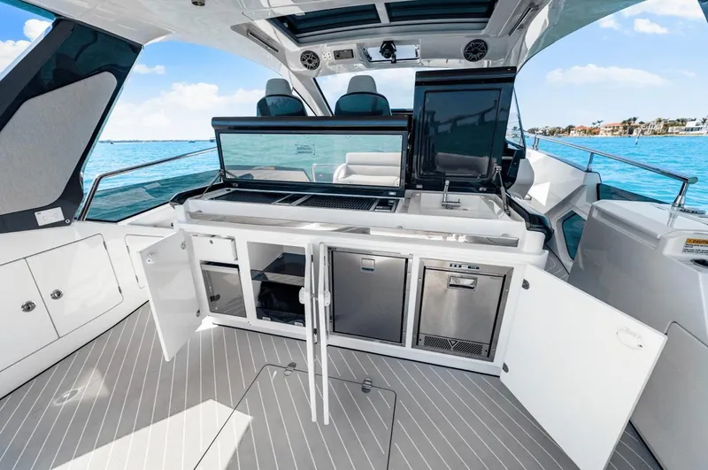 Slide: The Image of The 2025 Azimut Verve 48 features a modern outdoor kitchen with stainless steel appliances and storage. - 4