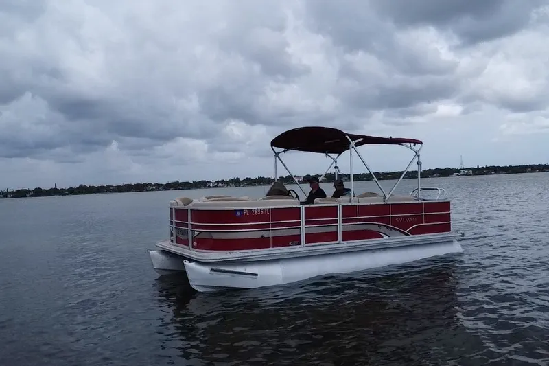 Slide: The Image of 2013 Sylvan Mirage Fish 8520 CNF pontoon boat on a calm lake under cloudy skies. - 19