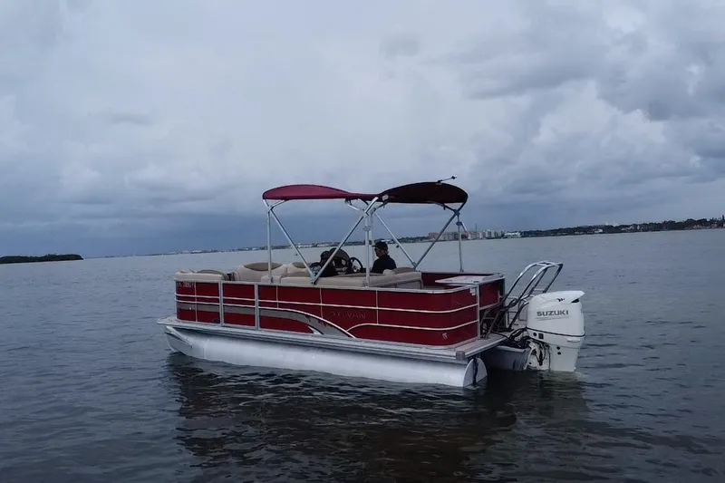 Slide: The Image of 2013 Sylvan Mirage Fish 8520 CNF pontoon boat on calm waters under cloudy skies. - 20