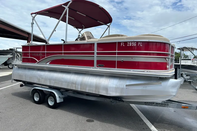 The Image of 2013 Sylvan Mirage Fish 8520 CNF pontoon boat with red exterior on a trailer. - 1