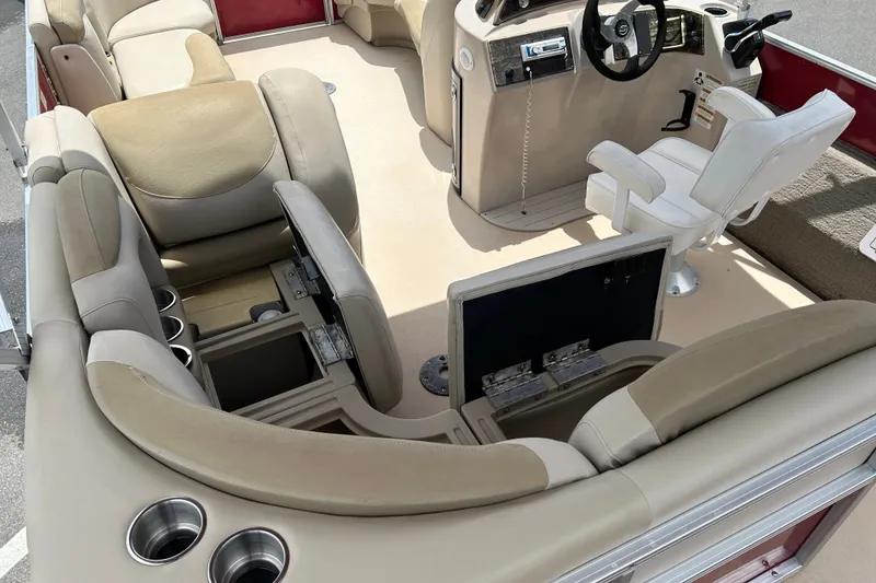 Slide: The Image of 2013 Sylvan Mirage Fish 8520 CNF boat interior with beige seating and storage compartments. - 17