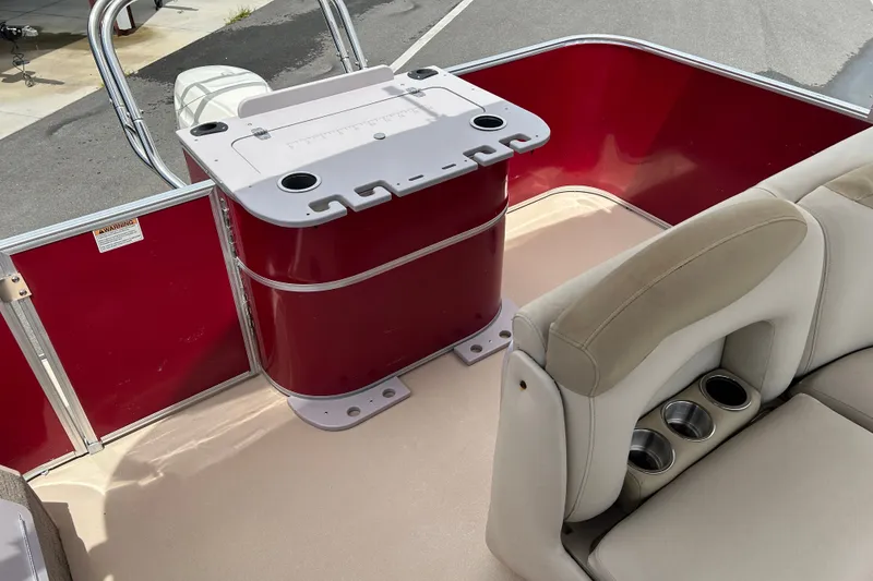 Slide: The Image of 2013 Sylvan Mirage Fish 8520 CNF boat interior with red paneling and beige seating. - 14