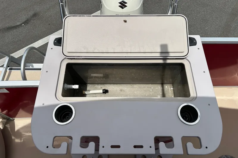 Slide: The Image of Open storage compartment on 2013 Sylvan Mirage Fish 8520 CNF boat, featuring cup holders. - 18