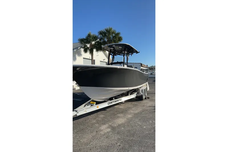 The Image of 2023 Sportsman Heritage 241 Center Console boat on trailer, parked outdoors. - 0