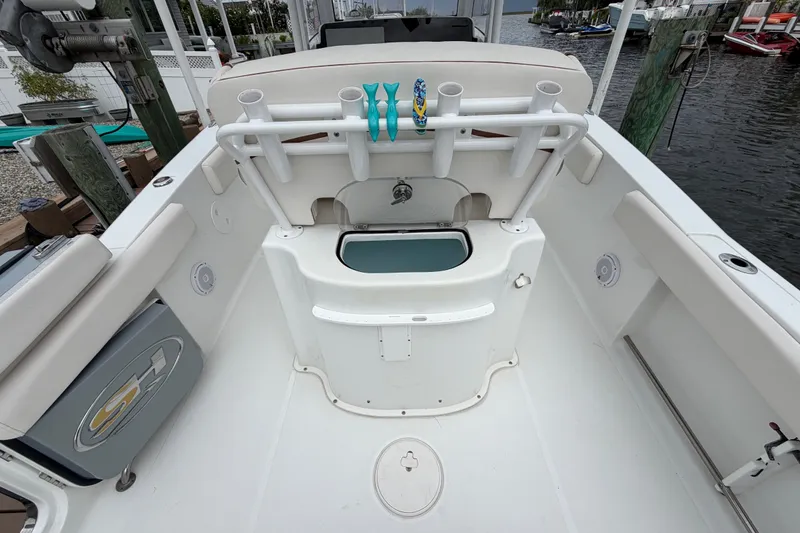 Slide: The Image of 2019 Sea Hunt Gamefish 25 boat interior with rod holders and storage compartments. - 15