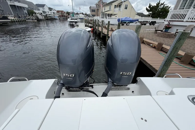 Slide: The Image of 2019 Sea Hunt Gamefish 25 with twin Yamaha 150 engines docked in a canal. - 12
