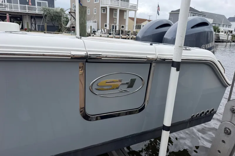 Slide: The Image of 2019 Sea Hunt Gamefish 25 boat docked, featuring Yamaha engines and sleek design. - 3
