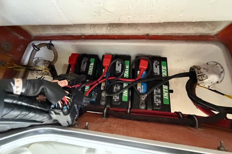 Slide: The Image of Battery compartment of a 2019 Sea Hunt Gamefish 25, featuring Interstate batteries and wiring. - 33